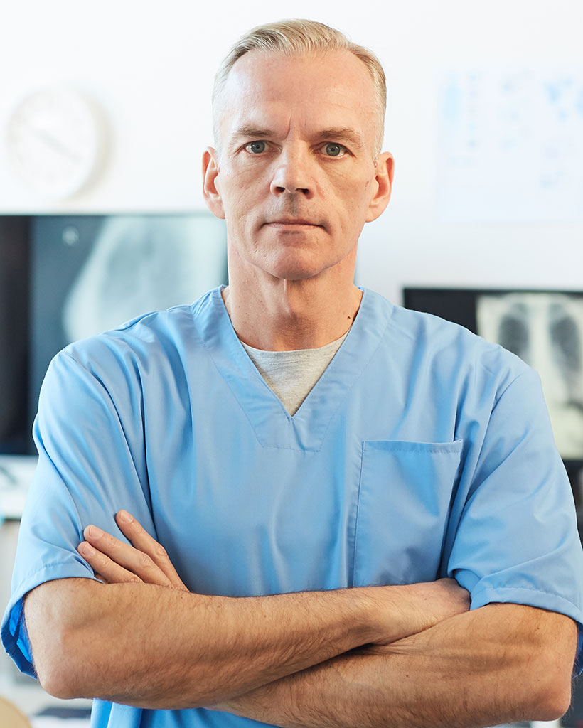 portrait-of-mature-doctor-posing-in-clinic-K9PMYGL.jpg